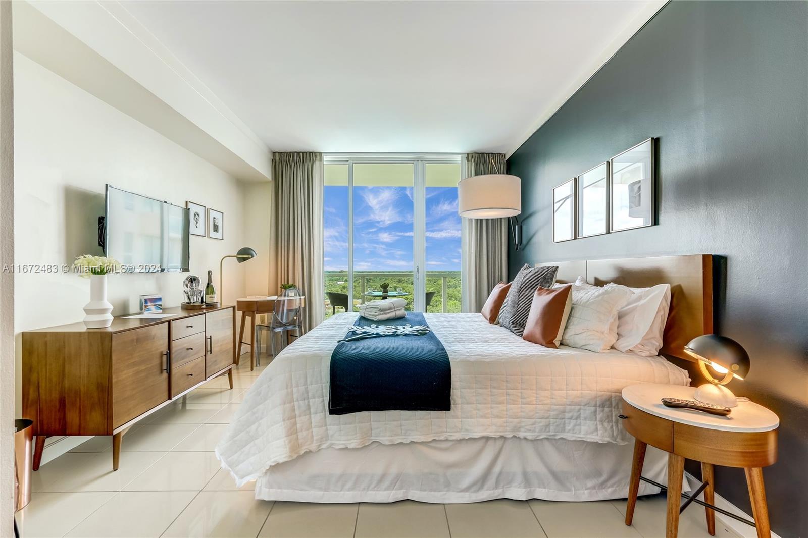 2889 McFarlane Road, Unit 904 Coconut Grove, FL 33133 - Photo 3 of 8 a large bedroom with a bed and wooden floor