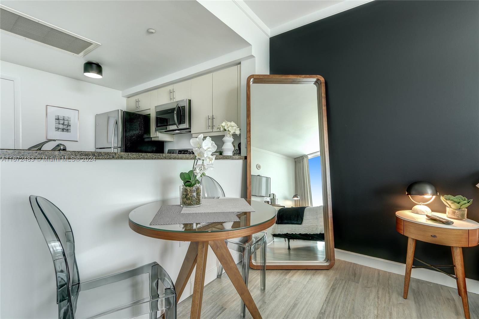 2889 McFarlane Road, Unit 904 Coconut Grove, FL 33133 - Photo 7 of 8 a view of a dining room with furniture and wooden floor