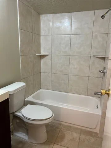 a bathroom with a toilet and bathtub