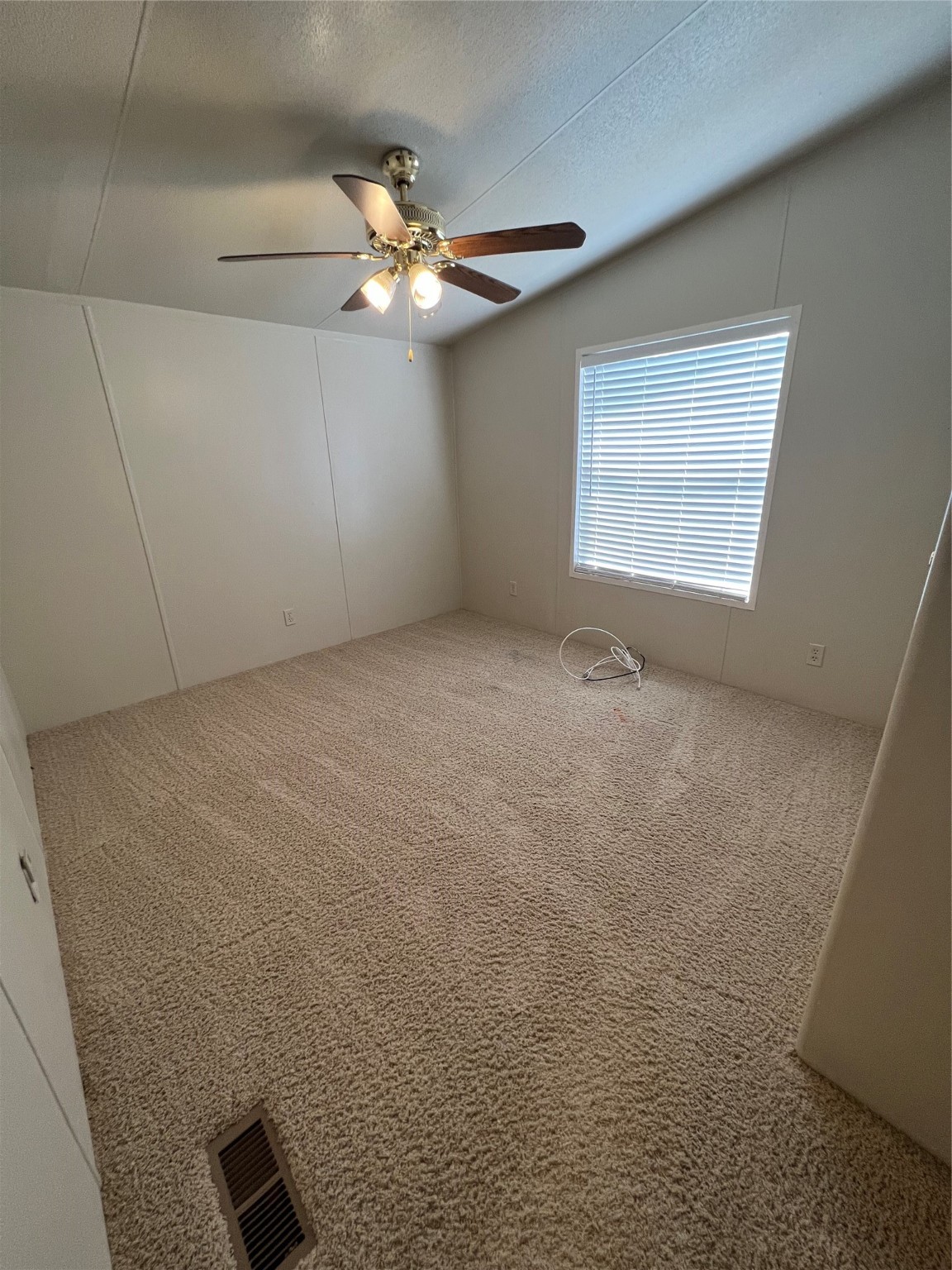 20431 Mountaindale Drive Cypress, TX 77433 - Photo 14 of 17 a view of an empty room with a chandelier fan