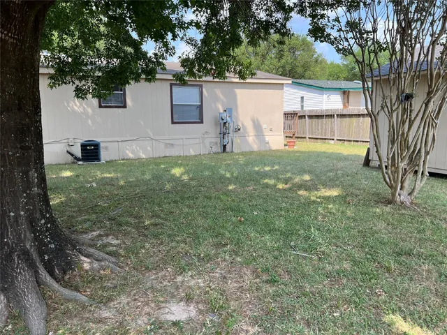 a view of a backyard with large trees