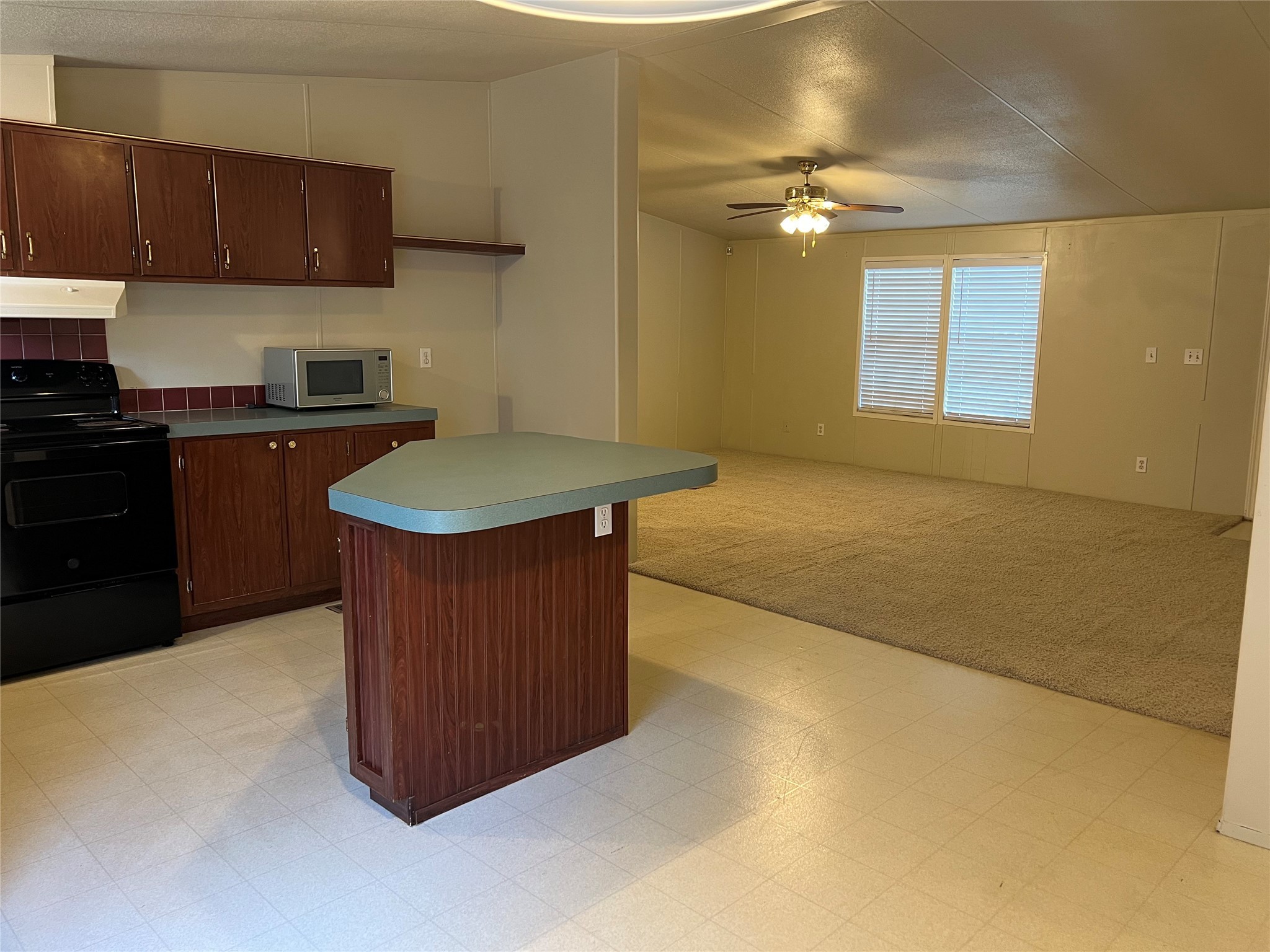 20431 Mountaindale Drive Cypress, TX 77433 - Photo 5 of 17 a kitchen with a sink a stove top oven a counter space and cabinets