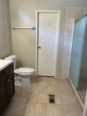 a bathroom with a toilet a sink and shower