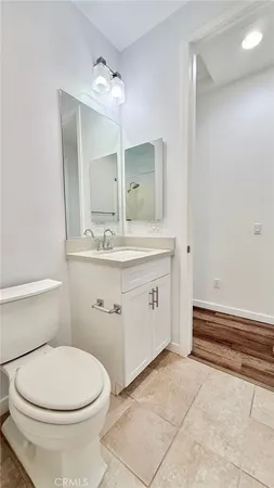 a bathroom with a sink a toilet and mirror