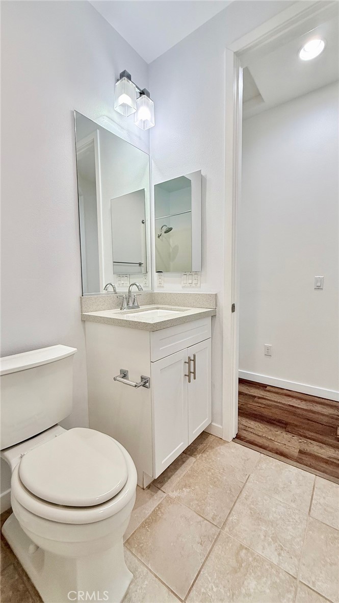 713 South Azusa Avenue, Unit A Azusa, CA 91702 - Photo 11 of 24 a bathroom with a sink a toilet and mirror