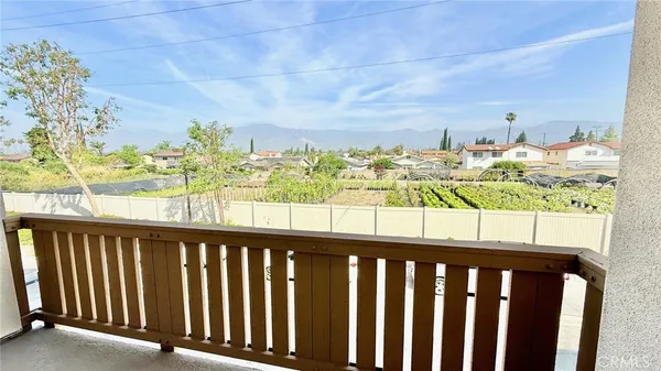 a view of a balcony with wooden floor and outdoor space