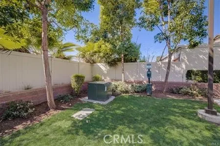 a view of a backyard with plants and a barbeque