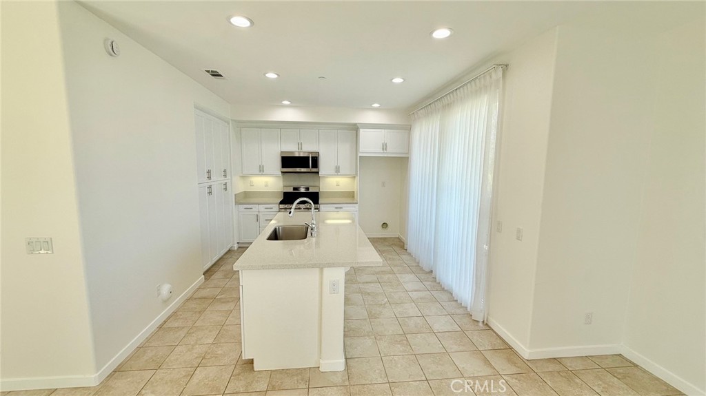 713 South Azusa Avenue, Unit A Azusa, CA 91702 - Photo 3 of 24 a kitchen with stainless steel appliances a microwave a sink and a refrigerator
