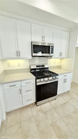 a kitchen with stainless steel appliances cabinets a sink and a stove