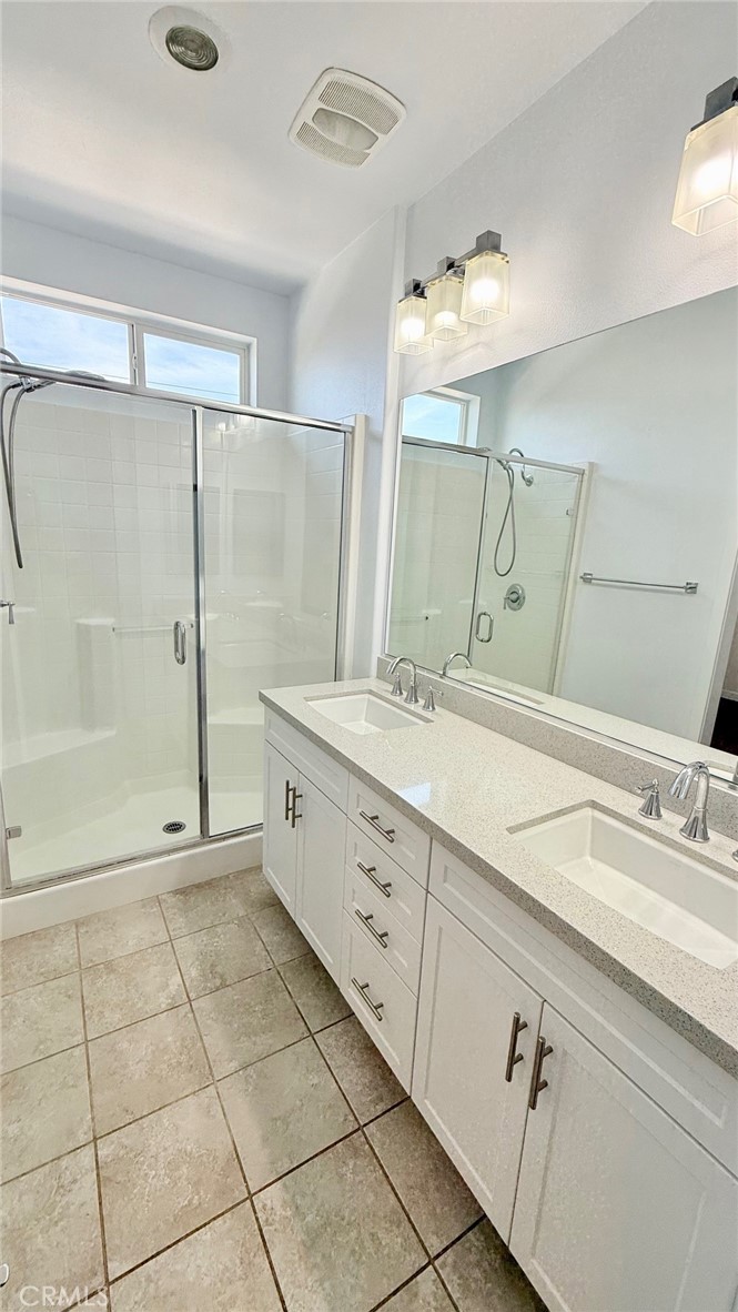 713 South Azusa Avenue, Unit A Azusa, CA 91702 - Photo 9 of 24 a bathroom with a double vanity sink mirror and shower