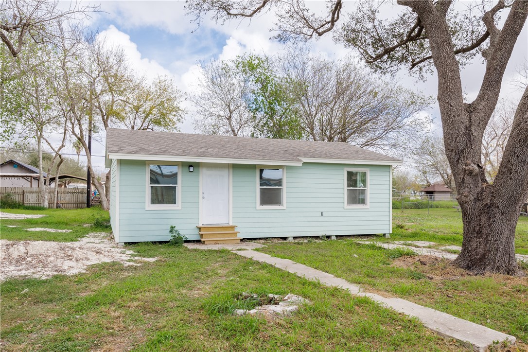 306 Allison Drive Gregory, TX 78359 - Photo 1 of 27 a view of a yard in front of a house with large trees