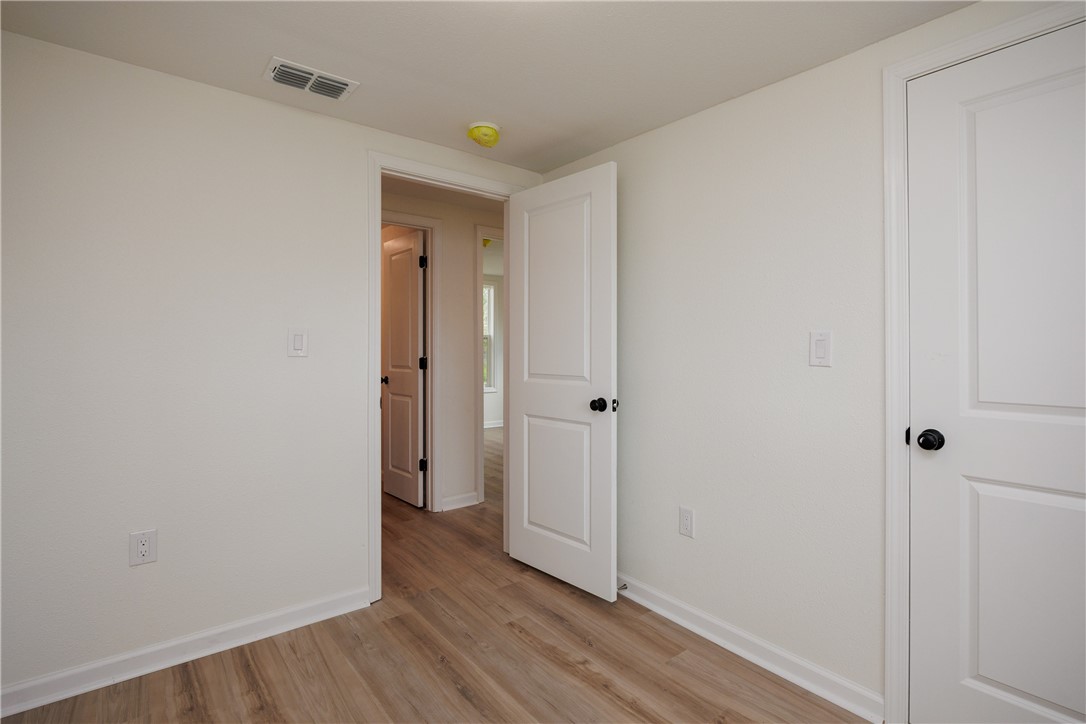 306 Allison Drive Gregory, TX 78359 - Photo 14 of 27 a view of a hallway with wooden floor