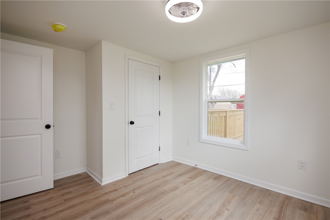 306 Allison Drive Gregory, TX 78359 - Photo 19 of 27 a view of an empty room with wooden floor and a window