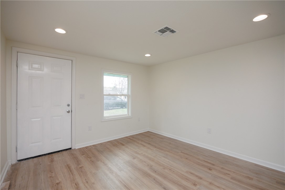 306 Allison Drive Gregory, TX 78359 - Photo 5 of 27 wooden floor in an empty room with a window