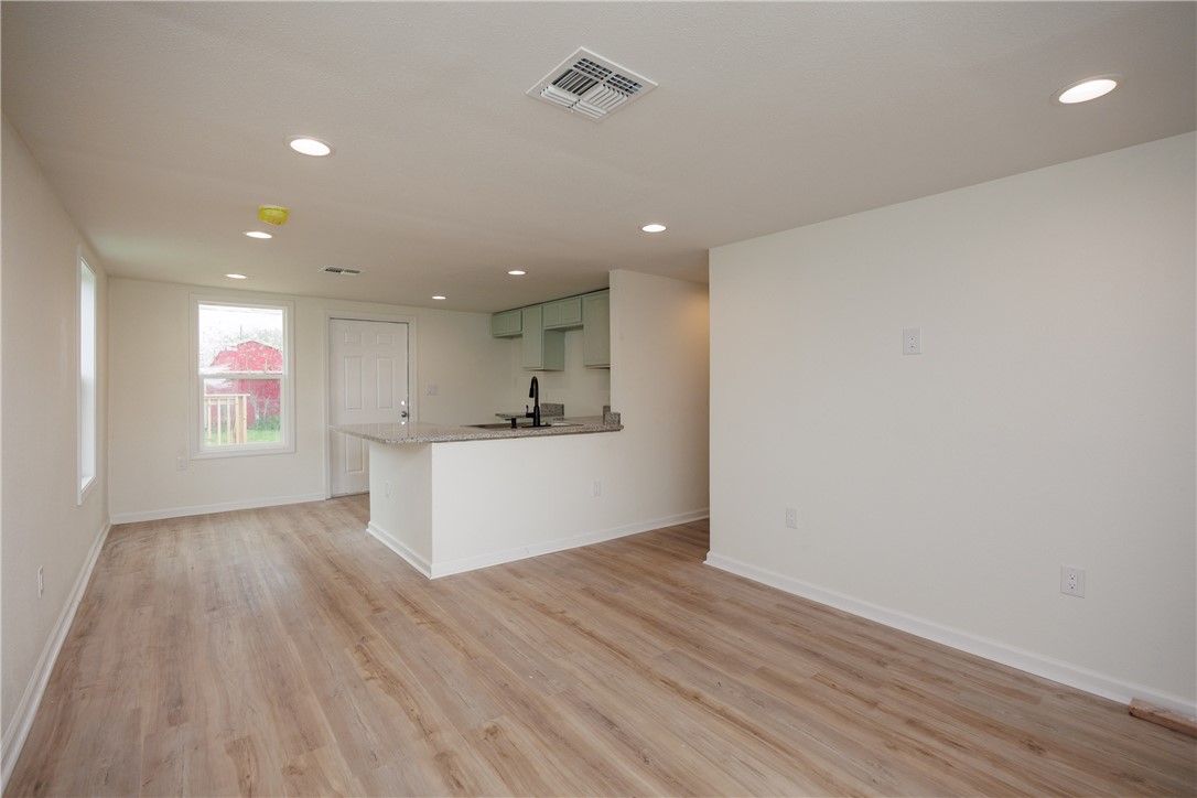 306 Allison Drive Gregory, TX 78359 - Photo 27 of 27 wooden floor in an empty room with a window