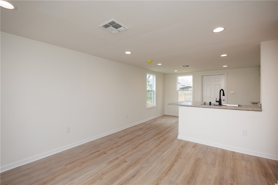 306 Allison Drive Gregory, TX 78359 - Photo 6 of 27 a view of kitchen with wooden floor and window