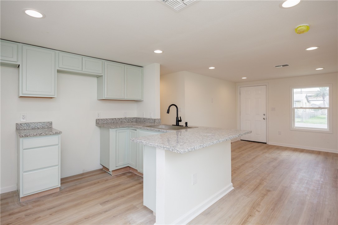 306 Allison Drive Gregory, TX 78359 - Photo 8 of 27 a kitchen with a sink cabinets and wooden floor