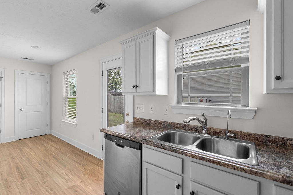408 Brigade Court Lebanon, TN 37087 - Photo 14 of 36 a kitchen with granite countertop a sink and a stove top oven