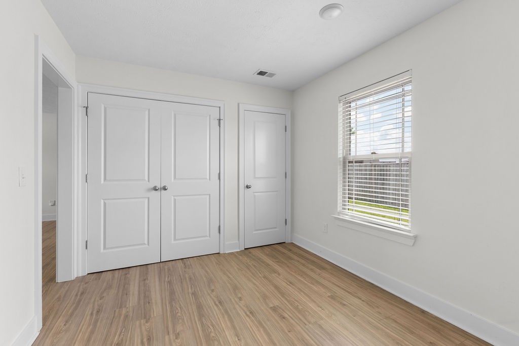 408 Brigade Court Lebanon, TN 37087 - Photo 16 of 36 a view of an empty room with wooden floor and a window
