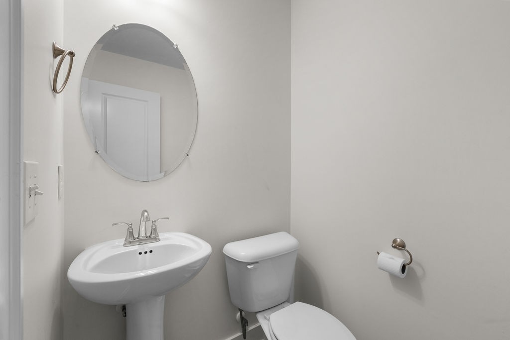 408 Brigade Court Lebanon, TN 37087 - Photo 17 of 36 a bathroom with a toilet sink and mirror