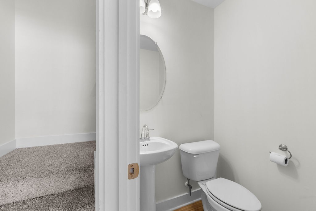 408 Brigade Court Lebanon, TN 37087 - Photo 19 of 36 a white toilet sitting next to a shower curtain