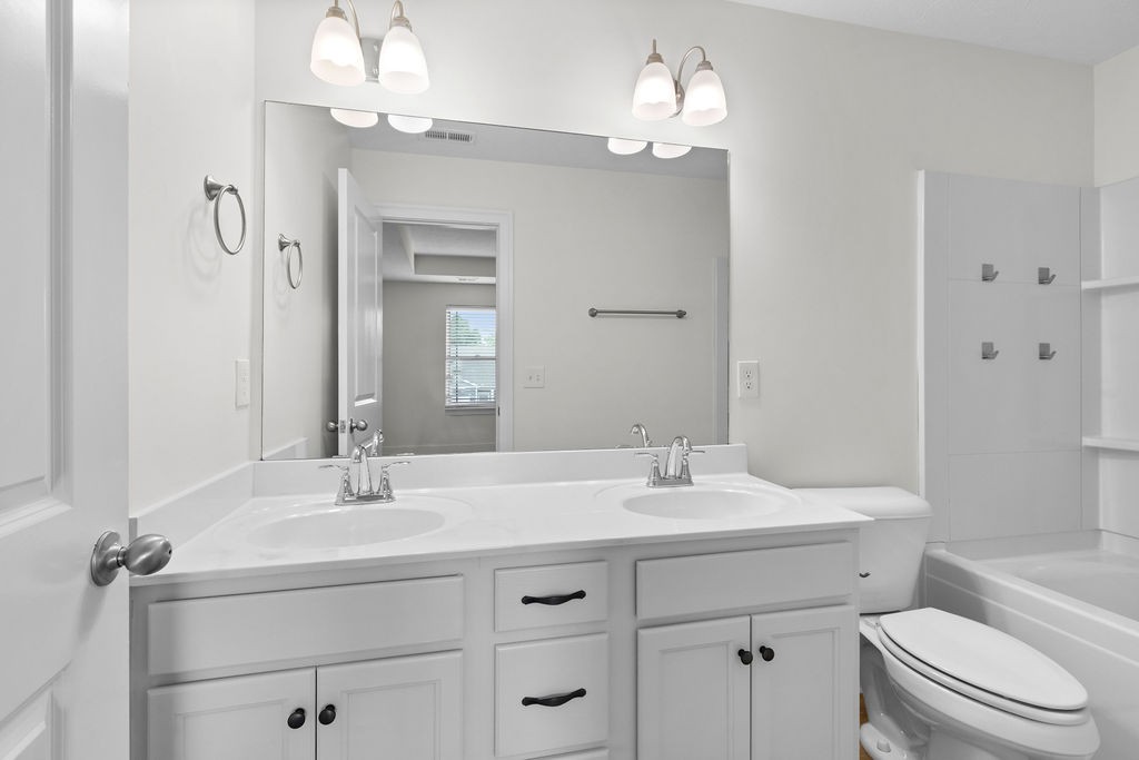 408 Brigade Court Lebanon, TN 37087 - Photo 22 of 36 a bathroom with a double vanity sink mirror and toilet