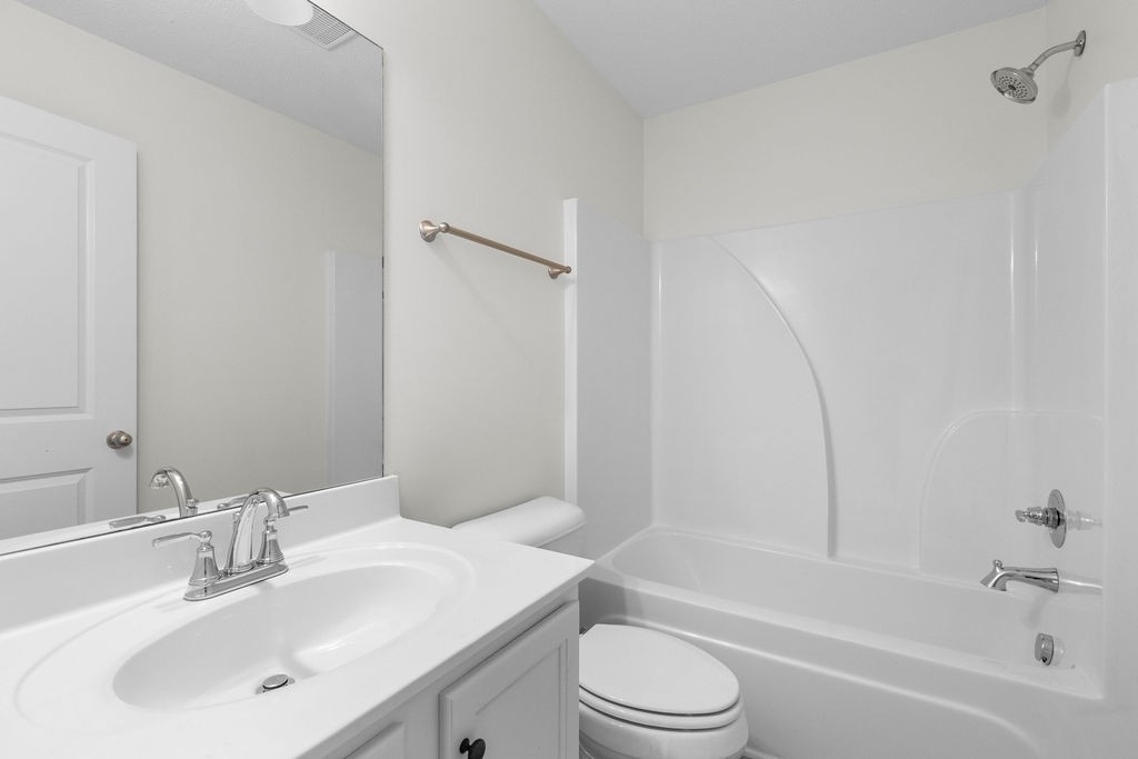 408 Brigade Court Lebanon, TN 37087 - Photo 29 of 36 a bathroom with a bathtub shower sink vanity mirror and toilet