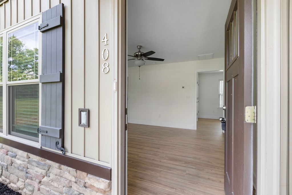 408 Brigade Court Lebanon, TN 37087 - Photo 3 of 36 a view of a hallway with wooden floor and a bathroom