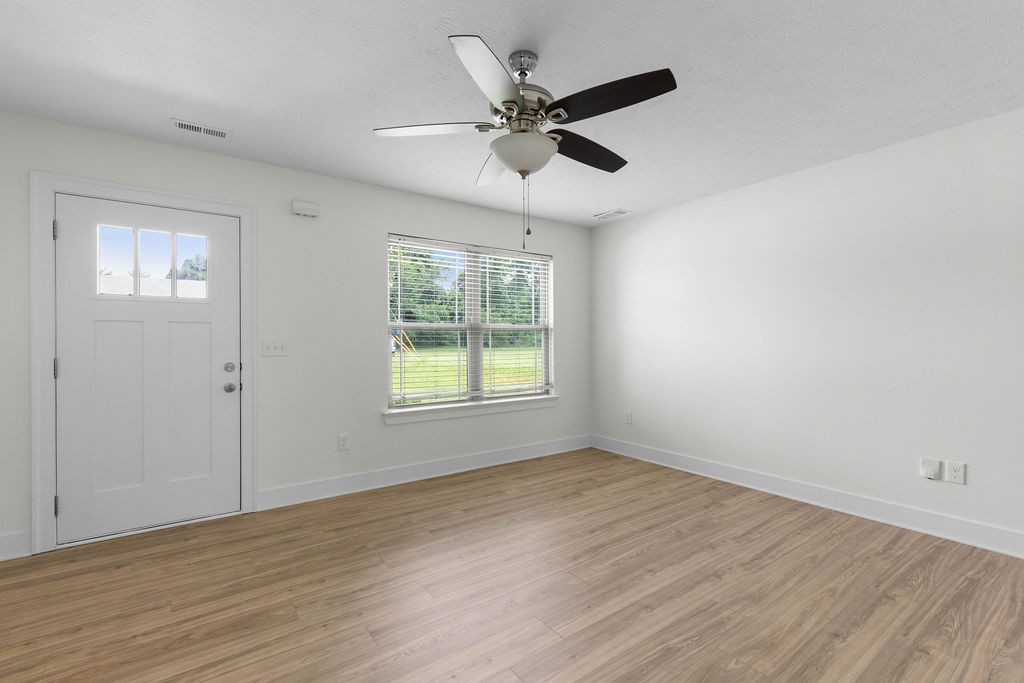 408 Brigade Court Lebanon, TN 37087 - Photo 6 of 36 a view of an empty room with wooden floor and a window