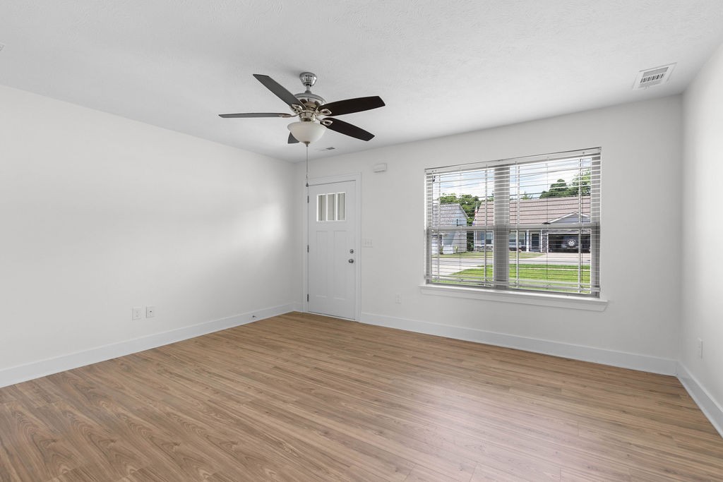 408 Brigade Court Lebanon, TN 37087 - Photo 7 of 36 a view of an empty room with a window and wooden floor