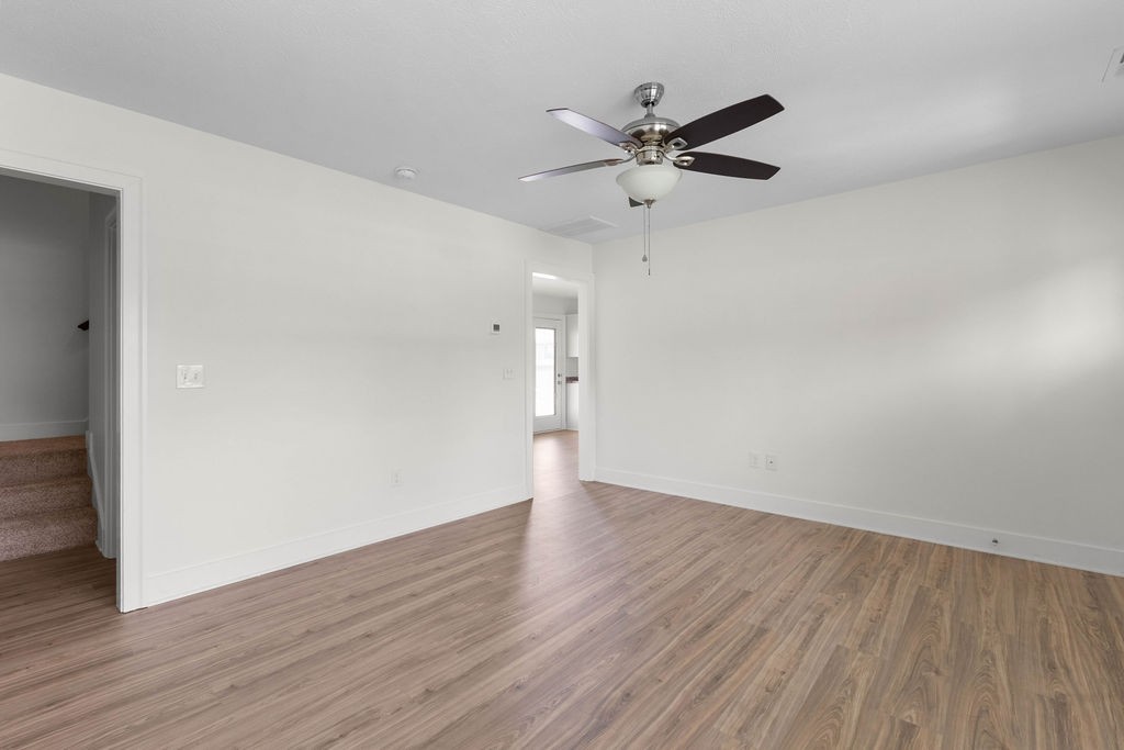 408 Brigade Court Lebanon, TN 37087 - Photo 8 of 36 a view of an empty room with wooden floor and a ceiling fan
