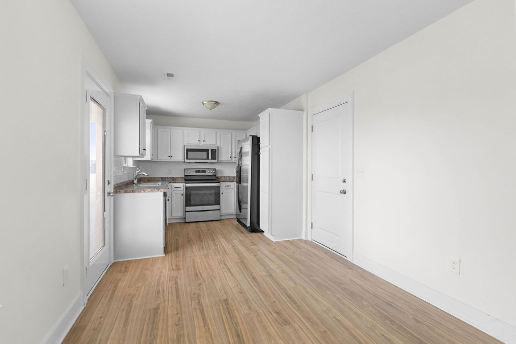 408 Brigade Court Lebanon, TN 37087 - Photo 10 of 36 a kitchen with wooden floors and appliances
