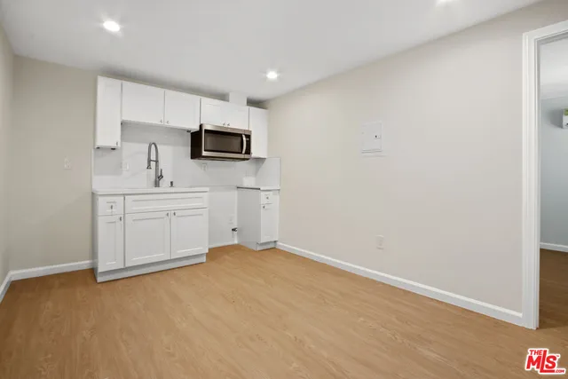a kitchen with stainless steel appliances a sink and microwave