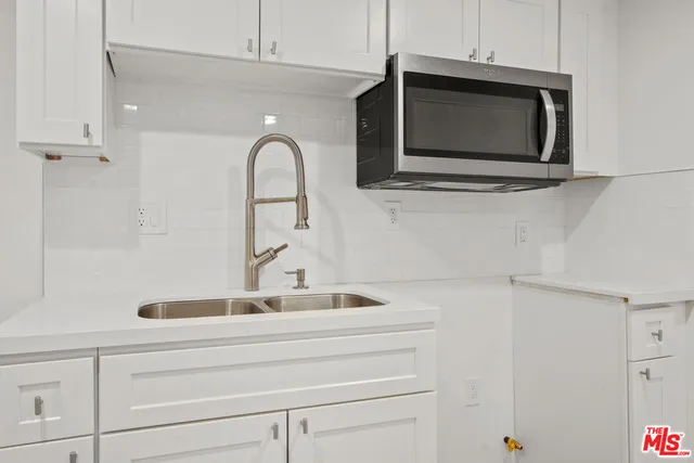 a bathroom with a sink and a microwave