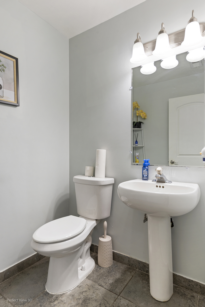 217 Oriole Road Matteson, IL 60443 - Photo 11 of 22 a bathroom with a sink a toilet and mirror