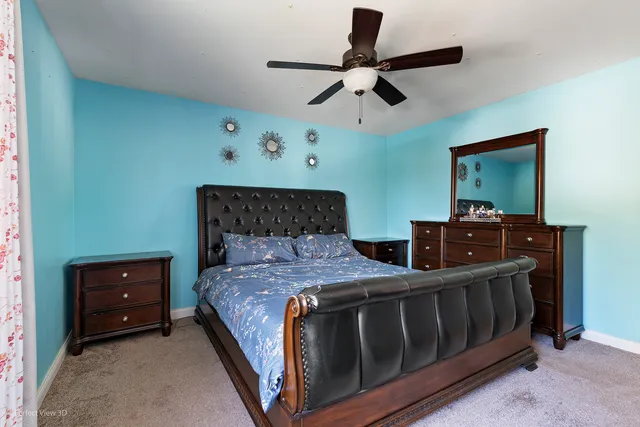 a bedroom with bed and a chandelier