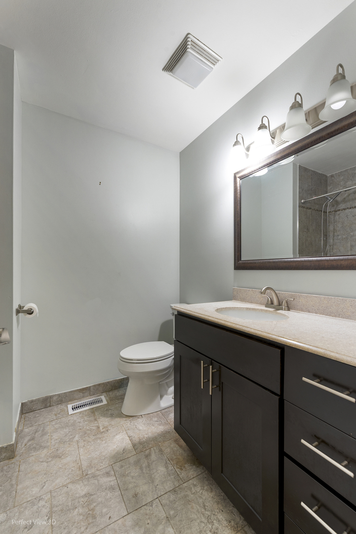 217 Oriole Road Matteson, IL 60443 - Photo 16 of 22 a bathroom with a toilet sink and mirror