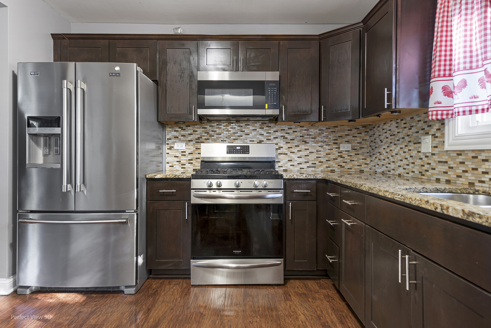 217 Oriole Road Matteson, IL 60443 - Photo 3 of 22 a kitchen with granite countertop stainless steel appliances and wooden cabinets