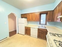 5 Saybrook Street, Unit 1 Boston, MA 02135 - Photo 2 of 7 a kitchen with a refrigerator sink stove and cabinets