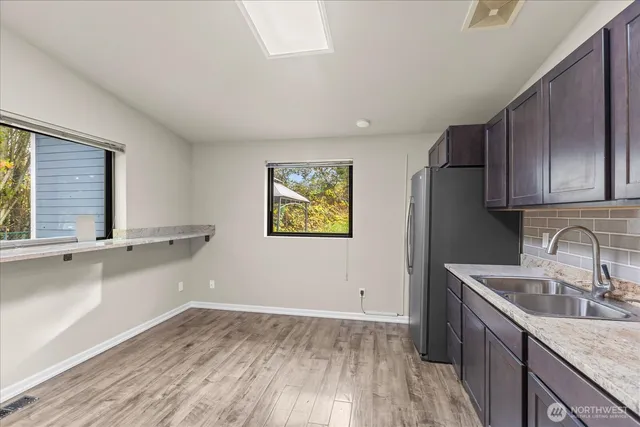 a kitchen with stainless steel appliances granite countertop a refrigerator and a sink