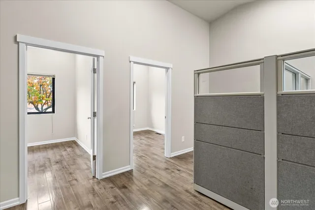 a view of a hallway with wooden floor