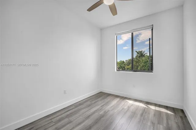 a view of an empty room and wooden floor