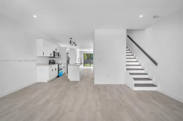 a kitchen with granite countertop a sink and a stove top oven