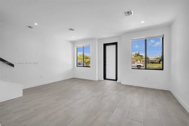 a view of an empty room with a sliding door