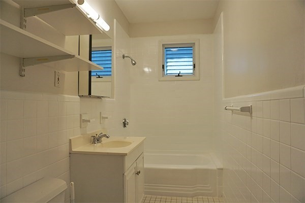 40 Calvin Street, Unit 2 Somerville, MA 02143 - Photo 7 of 12 a bathroom with a sink a toilet and shower