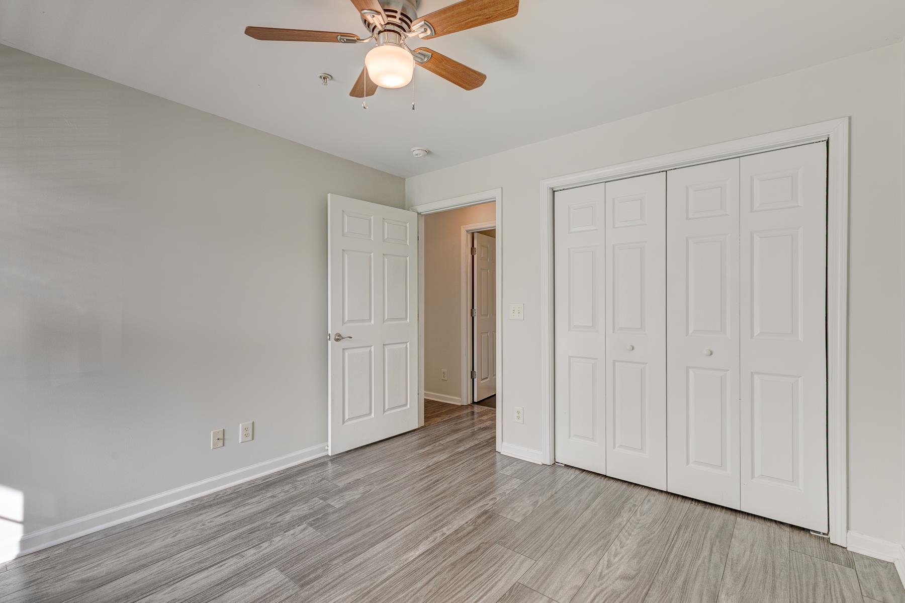 4826 Innisbrook Court, Unit 905 Myrtle Beach, SC 29579 - Photo 23 of 36 Unfurnished bedroom featuring a ceiling fan, a closet, and light wood-style floors