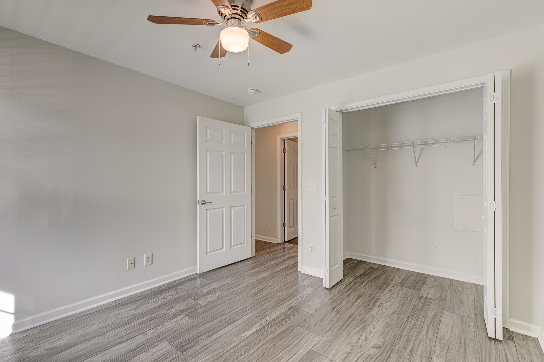 4826 Innisbrook Court, Unit 905 Myrtle Beach, SC 29579 - Photo 27 of 36 Unfurnished bedroom with ceiling fan, a closet, and light wood-type flooring