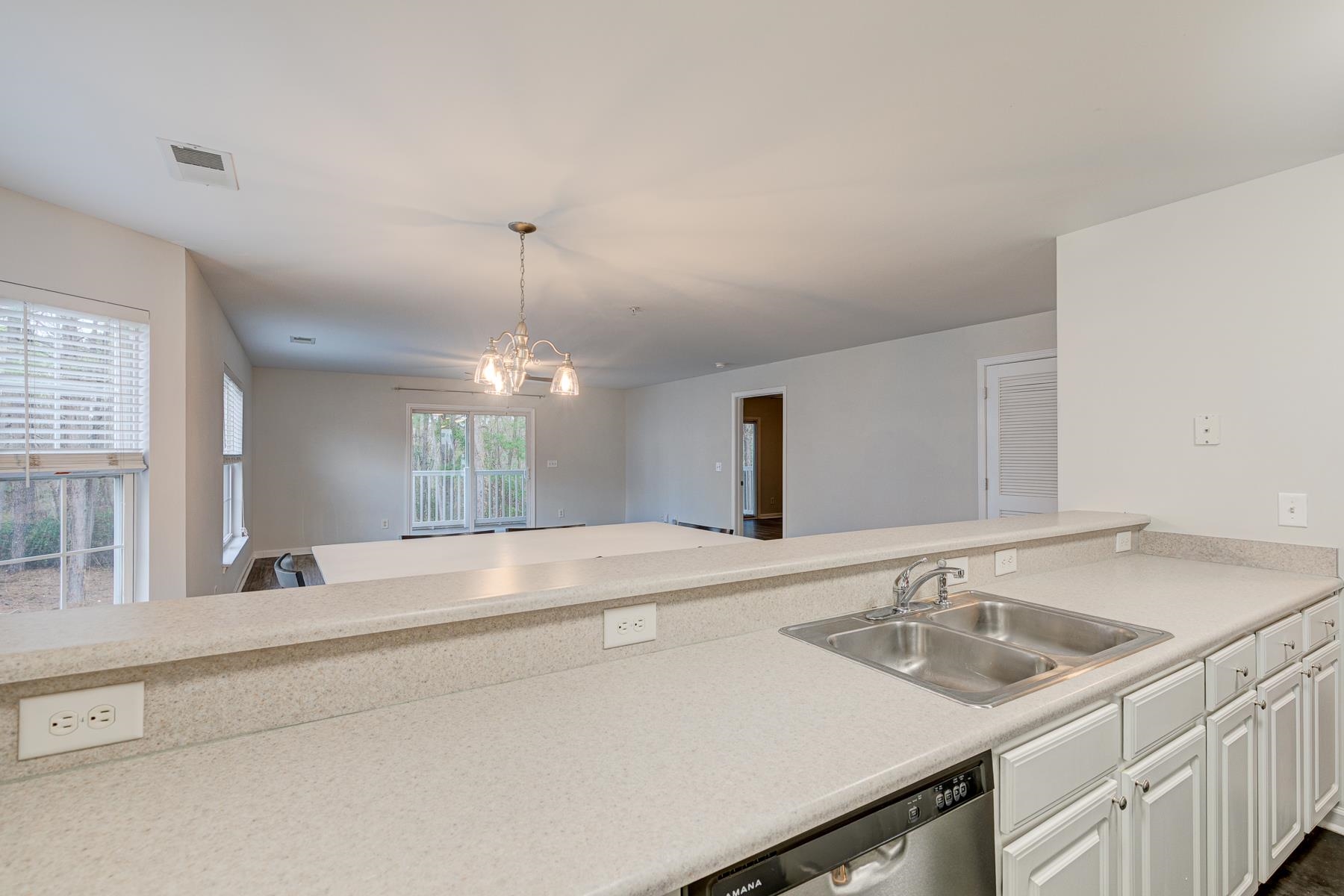 4826 Innisbrook Court, Unit 905 Myrtle Beach, SC 29579 - Photo 36 of 36 Kitchen with light countertops, dishwasher, white cabinetry, decorative light fixtures, and open floor plan