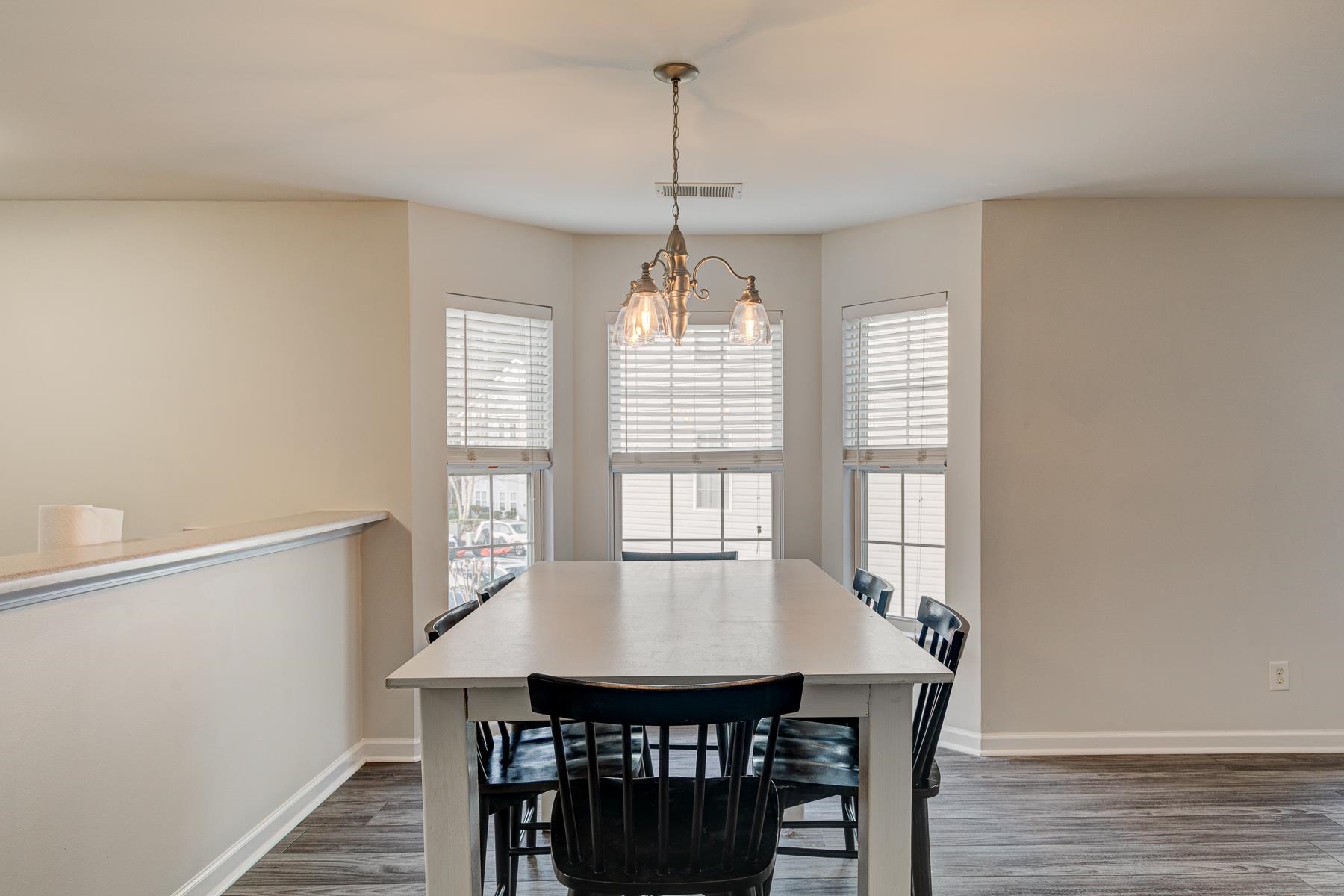 4826 Innisbrook Court, Unit 905 Myrtle Beach, SC 29579 - Photo 8 of 36 Dining area featuring dark wood finished floors, plenty of natural light, and a chandelier
