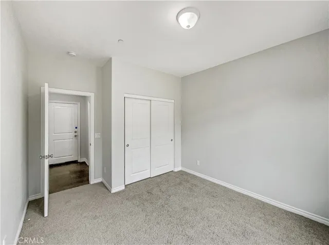 an empty room with closet area